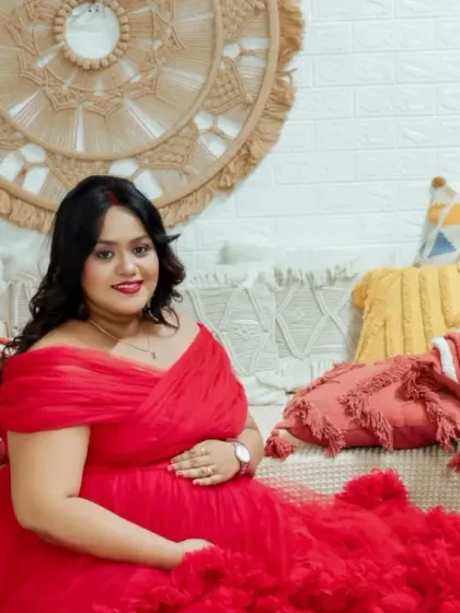 A cheerful portrait in our colorful boho setup. The mom-to-be's bright smile and the vibrant red gown bring a lot of energy and happiness to this shot.
