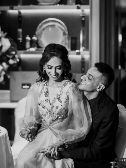 A sweet, candid moment from an engagement party. The groom's adoring look and the soft indoor lighting create a very romantic mood in this black and white photo.