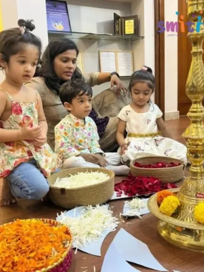 A group of children listens to a story about Onam, surrounded by baskets of colorful flowers. Storytelling is a powerful tool we use to bring cultural traditions to life.
