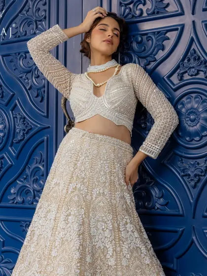 An ethereal vision in blush. This intricately hand-embellished lehenga from the 'Ruvaah' collection radiates timeless elegance, perfect for the bride who defines grace on her own terms.