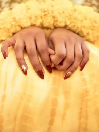 A close-up on the bride's hands, showcasing her beautiful manicure, a small but important detail.