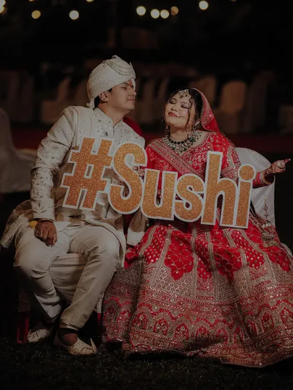 Another fun shot with their wedding hashtag. The couple's playful expressions show the joy and excitement of their special day.