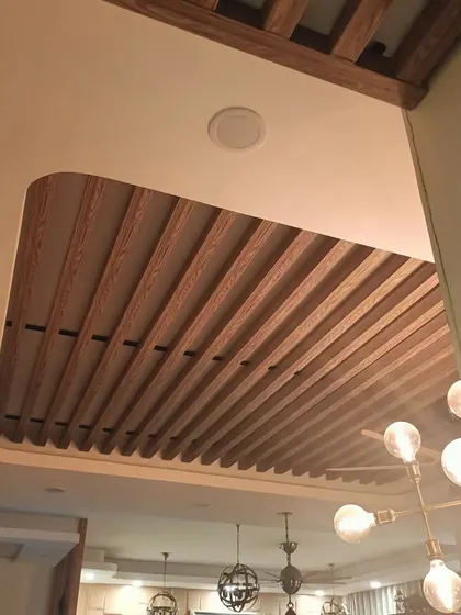 A detailed shot of a wooden rafter ceiling from our Bohemian-themed project. This architectural detail adds immense warmth, character, and a rustic-chic vibe to the dining area.