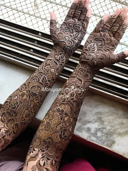 Full-arm bridal mehendi showcasing a blend of different textures and patterns.
