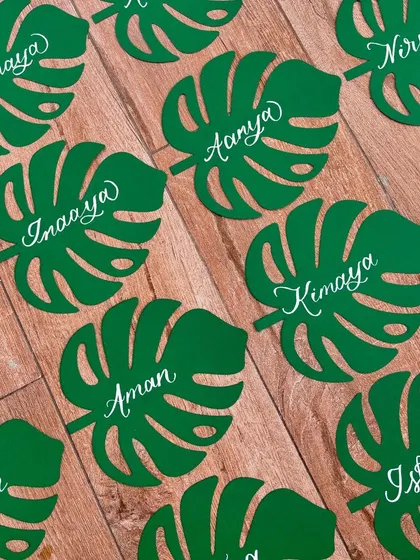 I absolutely loved creating these unique monstera leaf name tags for birthday party favors. The leaves were laser-cut from green cardstock, and I added each name in modern white calligraphy.
