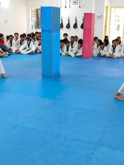 Two students perform their Poomsae on the mat.