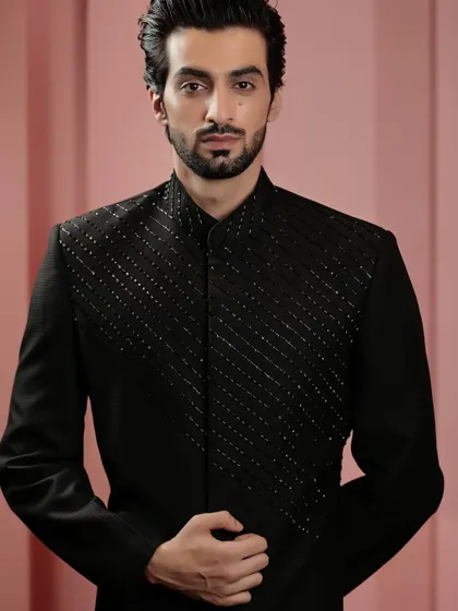 A close-up on the beaded chest panel of our black Indo-Western jacket. The craftsmanship is subtle yet impactful, adding a layer of sophistication.