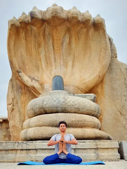 Seated before a magnificent sculpture of the Seshnag protecting the Shiva Lingam, I connect with the divine energy of Adi Yogi, the first yogi. My practice is deeply rooted in the spiritual traditions of India. I share these connections to help you understand yoga not just as exercise, but as a profound path to self-realization.