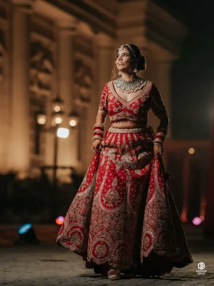 A full-length shot showcasing the entire bridal ensemble. The makeup, hair, and outfit all come together to create a cohesive and breathtaking look.