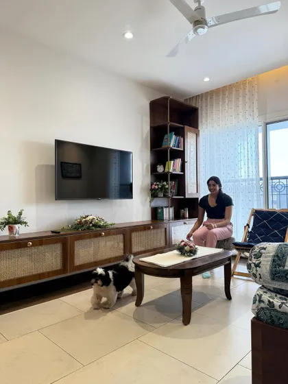 Mid-century modern with a soft spot for Netflix marathons. Also featuring a dog who pays no rent but runs the house. A living room with a custom cane-front TV console.