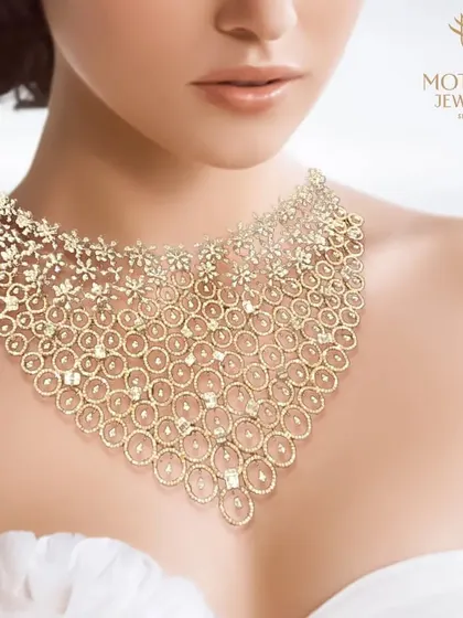 An image of a spectacular, wide diamond bib necklace, a masterpiece of intricate design and breathtaking sparkle.
