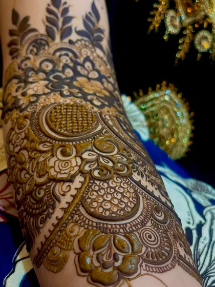 A close up detail shot of a bridal henna sleeve. Notice the fine dot work, shading, and intricate fills that give the design so much depth and texture.