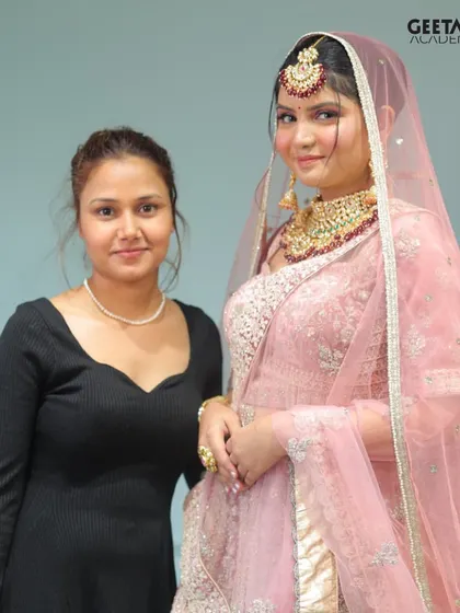 Student Work: A proud student stands with her model, showcasing a beautiful pink-themed bridal look. This is the result of dedicated learning and hands-on practice.