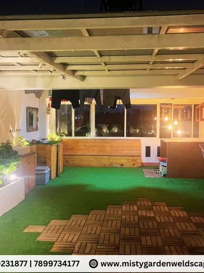 Another angle of the Banashankari terrace, showing the combination of artificial grass and WPC deck tiles used to create a practical and beautiful outdoor floor.