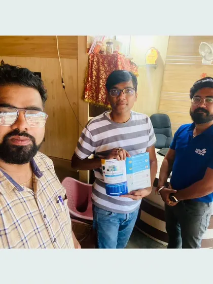 Our team with a customer holding our solar information packet.
