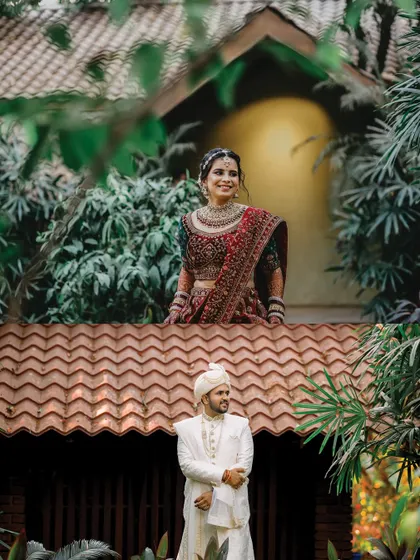 A creative composition with the bride on an upper level looking down at her groom. This shot plays with perspective and architecture to create a unique and memorable wedding portrait.