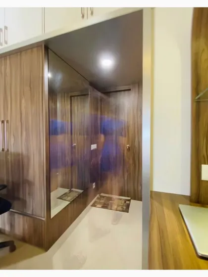 The entryway to the master bedroom includes a full-length mirror integrated into the wardrobe design, a technique we use to make spaces feel larger and brighter.