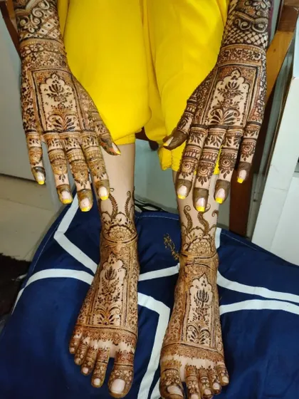 A beautiful example of matching hand and foot bridal mehndi. The design features traditional motifs that flow seamlessly from the arms down to the toes.