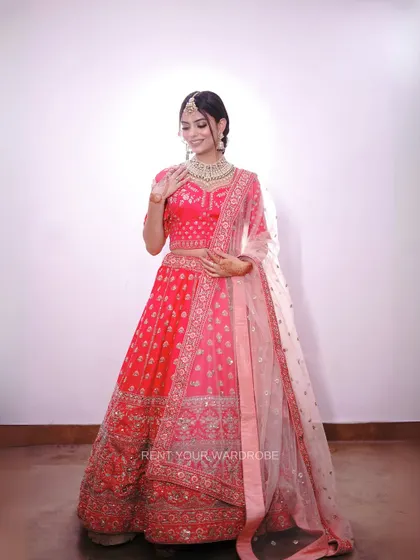 A full-length view of the pink lehenga, showing its beautiful ombre dupatta.