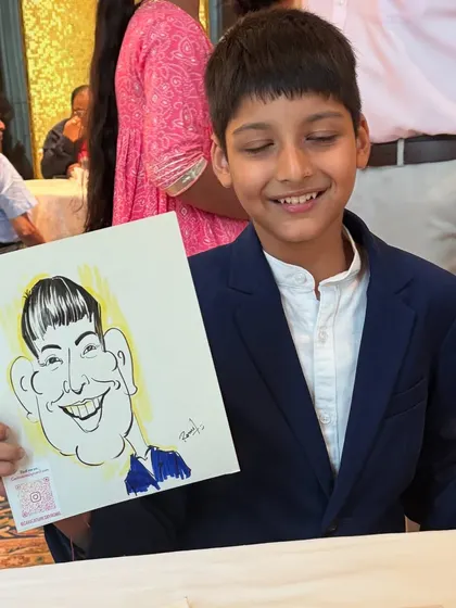 A young boy smiling with his caricature, a fun activity for kids at any party.