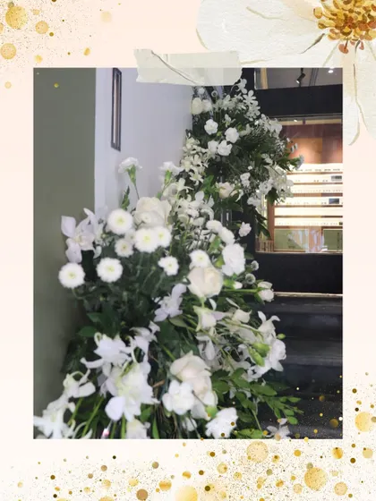 A close-up of the lush, all-white floral arrangements used at the GKB relaunch. The mix of textures from different flowers like carnations and daisies created a look that was both elegant and approachable.