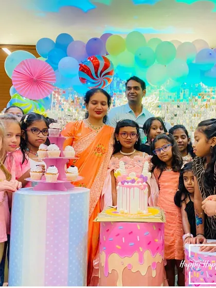 The birthday girl and her friends gathered around the cake at the Candyland party. Creating these happy, shared moments is the best part of my work.