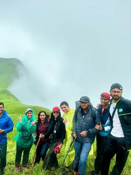 Another shot of the happy group, posing with their trekking poles on the green slopes.