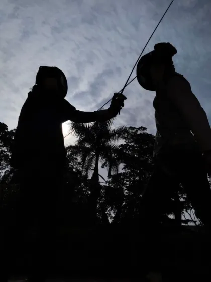 The silhouette of two fencers locked in a duel against the sky. This image represents the focus, discipline, and warrior spirit we instill in every athlete at our club.