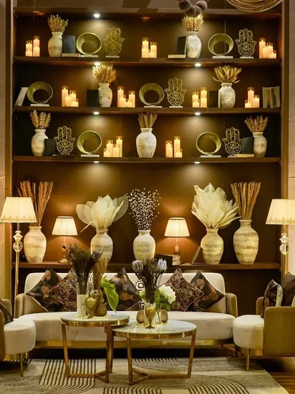 We designed this sophisticated lounge for a cocktail evening with a 'Mocha Mousse' color palette. The setting features a grand, fully-stocked back bar with earthen decor, plush seating, and warm ambient lighting, creating an inviting and elegant space for guests to relax and connect.