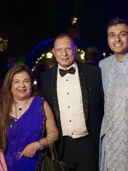 A lovely family photo with the newly engaged couple and their happy parents.