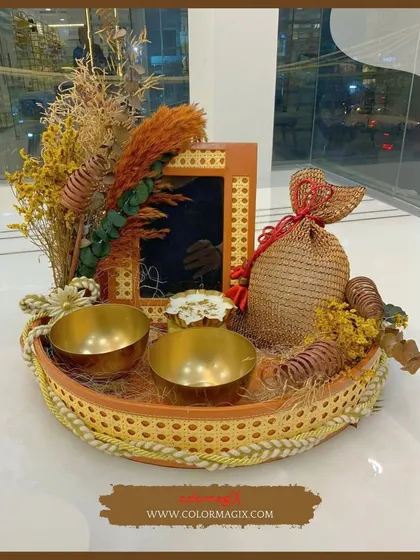 This rustic tray hamper is crafted from natural materials and decorated with dried flowers and brass bowls. It's an earthy and elegant option for any special occasion.