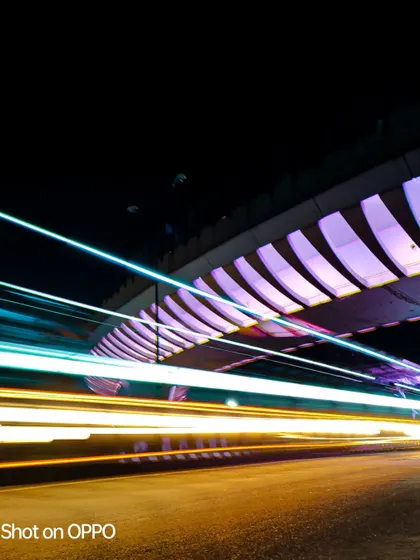 This version of the long-exposure bridge shot captures a mix of blue and white light trails, resulting in a clean, high-tech feel.