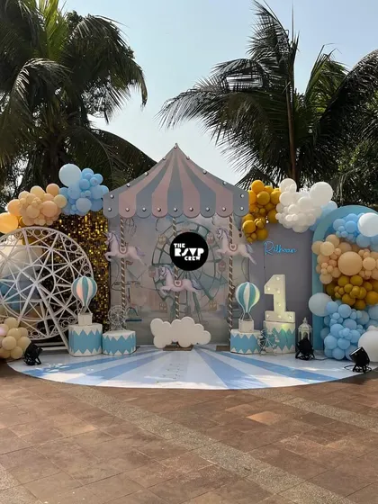 A wide shot of the pastel carnival setup in an outdoor location, perfect for a first birthday.