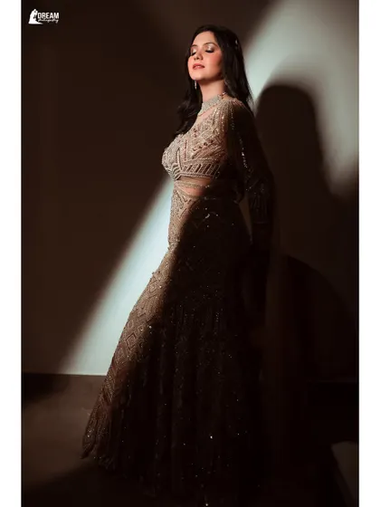 A beautifully lit portrait of bride Ekta, the dramatic shadows highlighting her features and the texture of her Sagan gown.