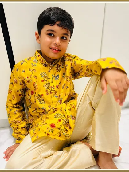 Another happy client looking dapper in a bright yellow floral kurta. Our printed kurtas are perfect for adding a pop of color to any festive occasion.