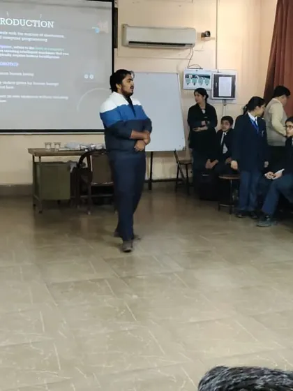 An instructor leads a presentation for students at Lions Public School, introducing them to emerging technologies and core concepts in our workshop.