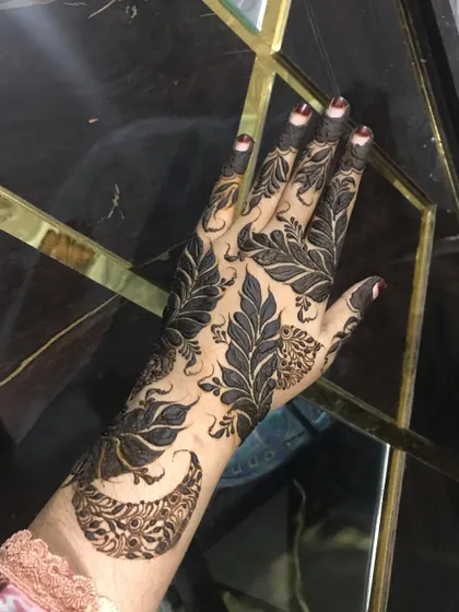 A clear shot of the Doha leaf design against a dark background.