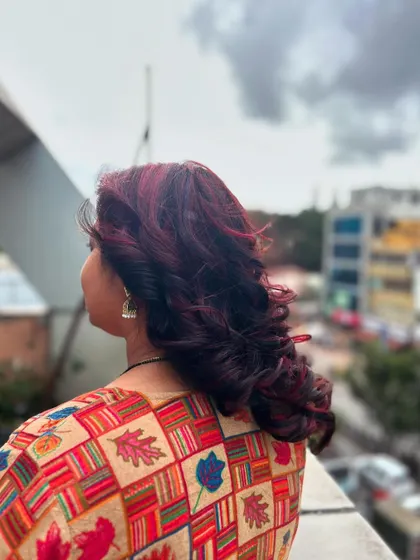 A gorgeous red hair color with voluminous curls. We teach our students how to select the right shade of red to complement skin tones and how to style the hair to best showcase the color.