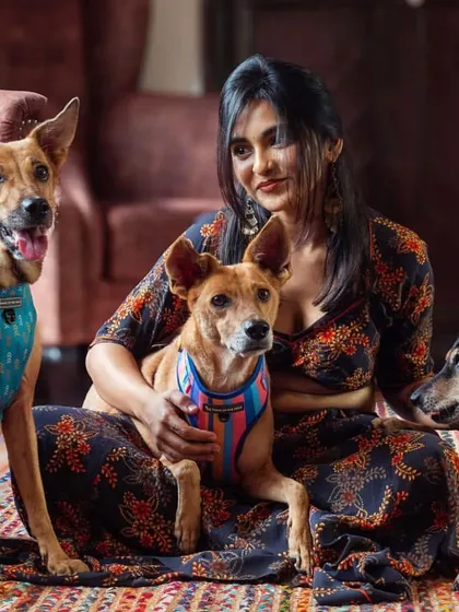 A beautiful portrait of a pet parent and her three indie dogs. My sessions are designed to handle the happy chaos of multiple pets, ensuring we get a shot that celebrates your entire pack.