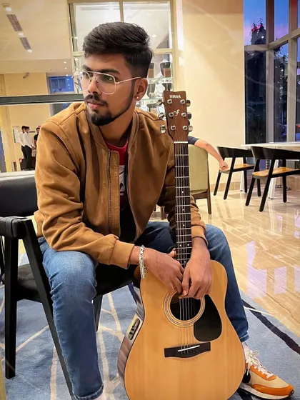Taking a quiet moment with my guitar before a gig. The time before a show is for focus and preparation, ensuring I'm ready to give my best to the audience.