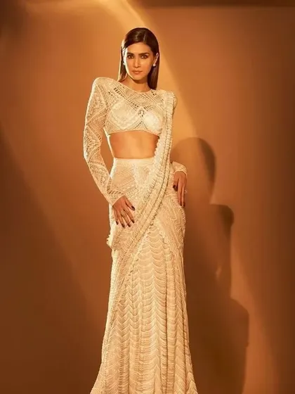 A fully beaded, fitted white saree-gown is the height of glamour. I can create a custom-fit version of this red-carpet-worthy look for your reception or cocktail party.