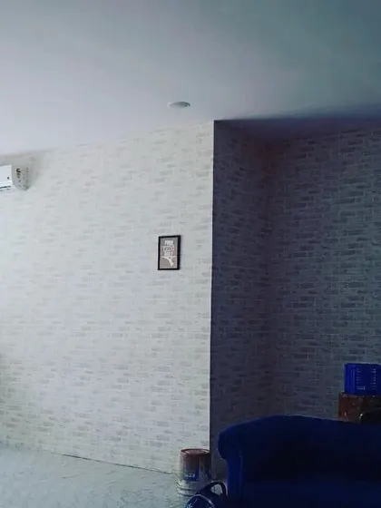 A full view of a cafe or lounge space I worked on, featuring a clean, white brick effect wallpaper. It instantly brightens the space and gives it a modern, urban vibe.