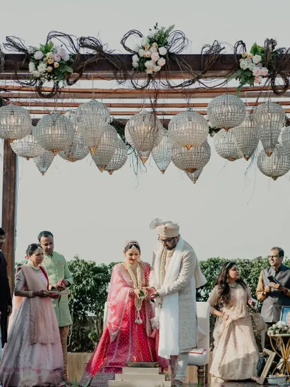 Another angle of the rustic-chic mandap, showing the contrast between the natural wood and the glamorous crystals.