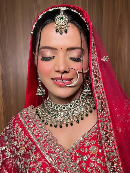 A detailed shot of the eye makeup for this classic North Indian bridal look. The soft, blended eyeshadow and perfect lashes enhance her eyes beautifully, even when closed.