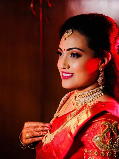 A profile shot showing off the elegant hairstyle and makeup. The look was designed to be beautiful from every angle.
