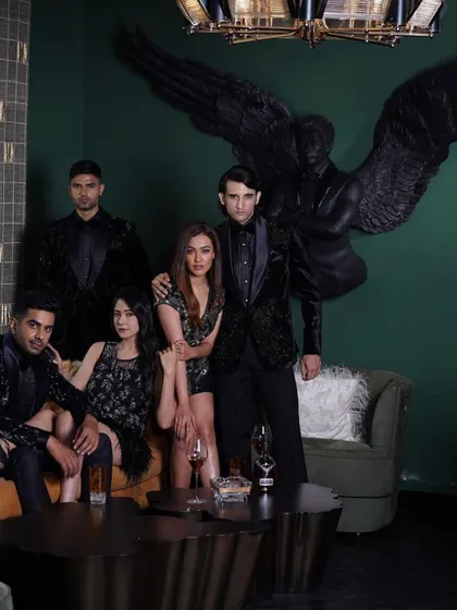 A group of models showcasing our 'Stars of the Night' collection. This image captures the sophisticated and glamorous aesthetic we aim for in both our men's and women's evening wear.