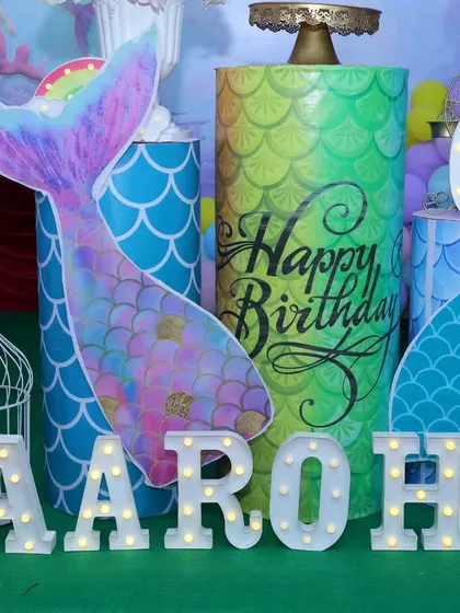 A magical mermaid-themed birthday party setup. We used iridescent colors, mermaid tail cutouts, and marquee letters spelling out the name to create an underwater fantasy world.