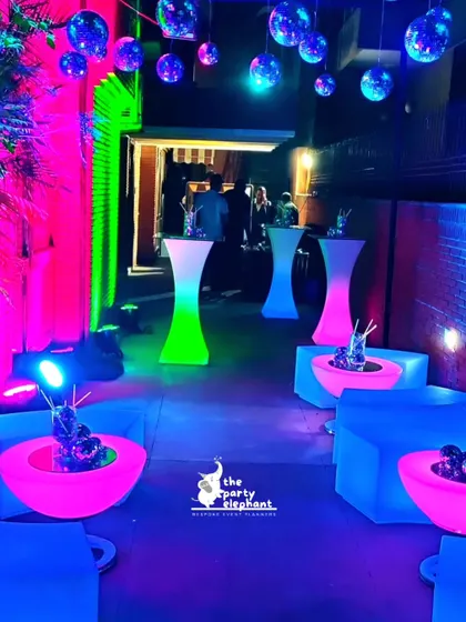 The combination of pink and blue uplighting on the walls and the glowing LED furniture created a stunning visual effect in the outdoor lounge area of the Ibiza-themed party.