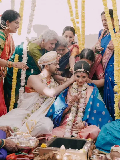 A duplicate of the family blessing the couple during the mangalsutra ceremony.