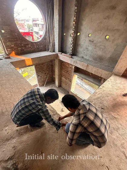 This high-angle shot captures the initial site observation. I am assessing the double-height space and the large circular window, planning how to use these unique architectural features to create a dramatic and light-filled interior.